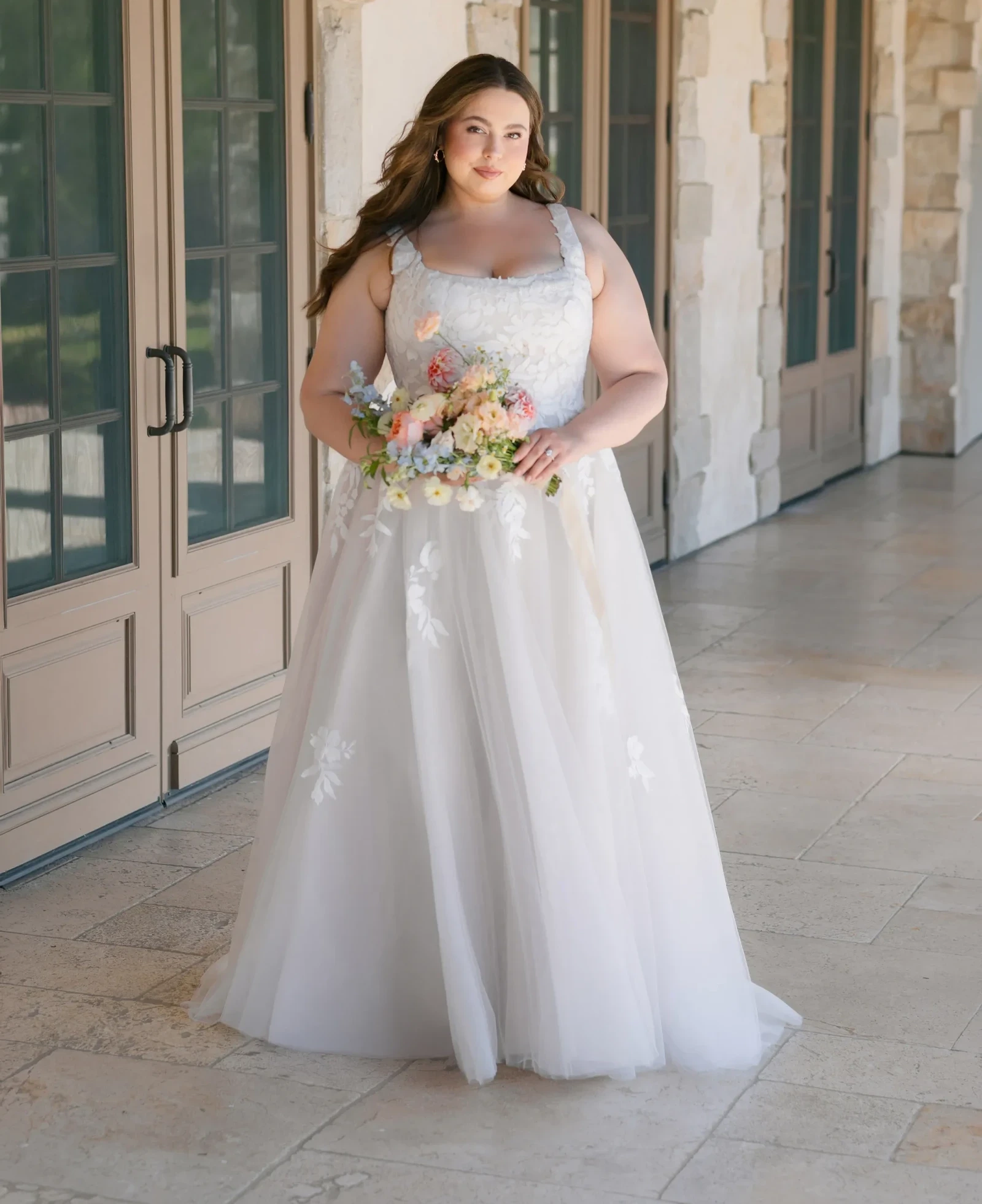 Model wearing a plus size gown by Allure Plus