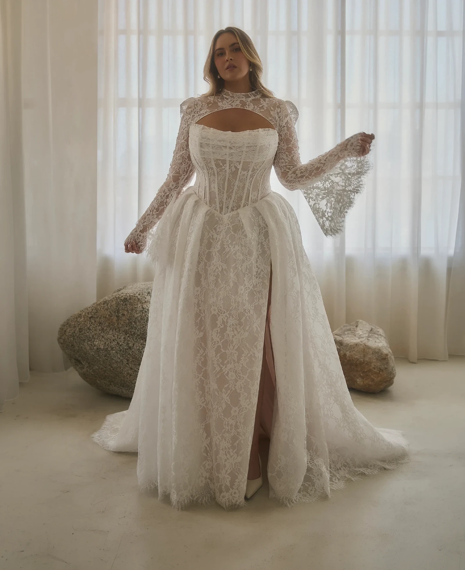Model wearing a plus size gown by Casablanca Bridal