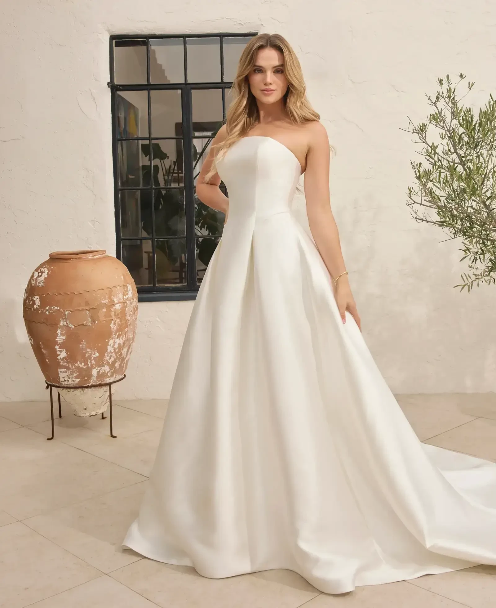 Model wearing a gown by Beloved by Casablanca
