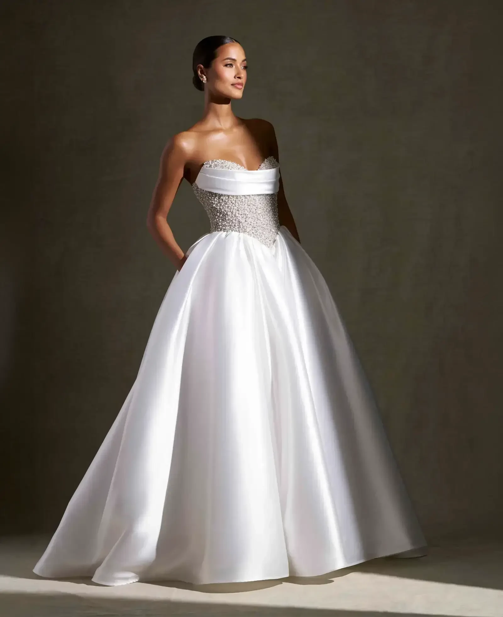 Model wearing a gown by Allure Couture