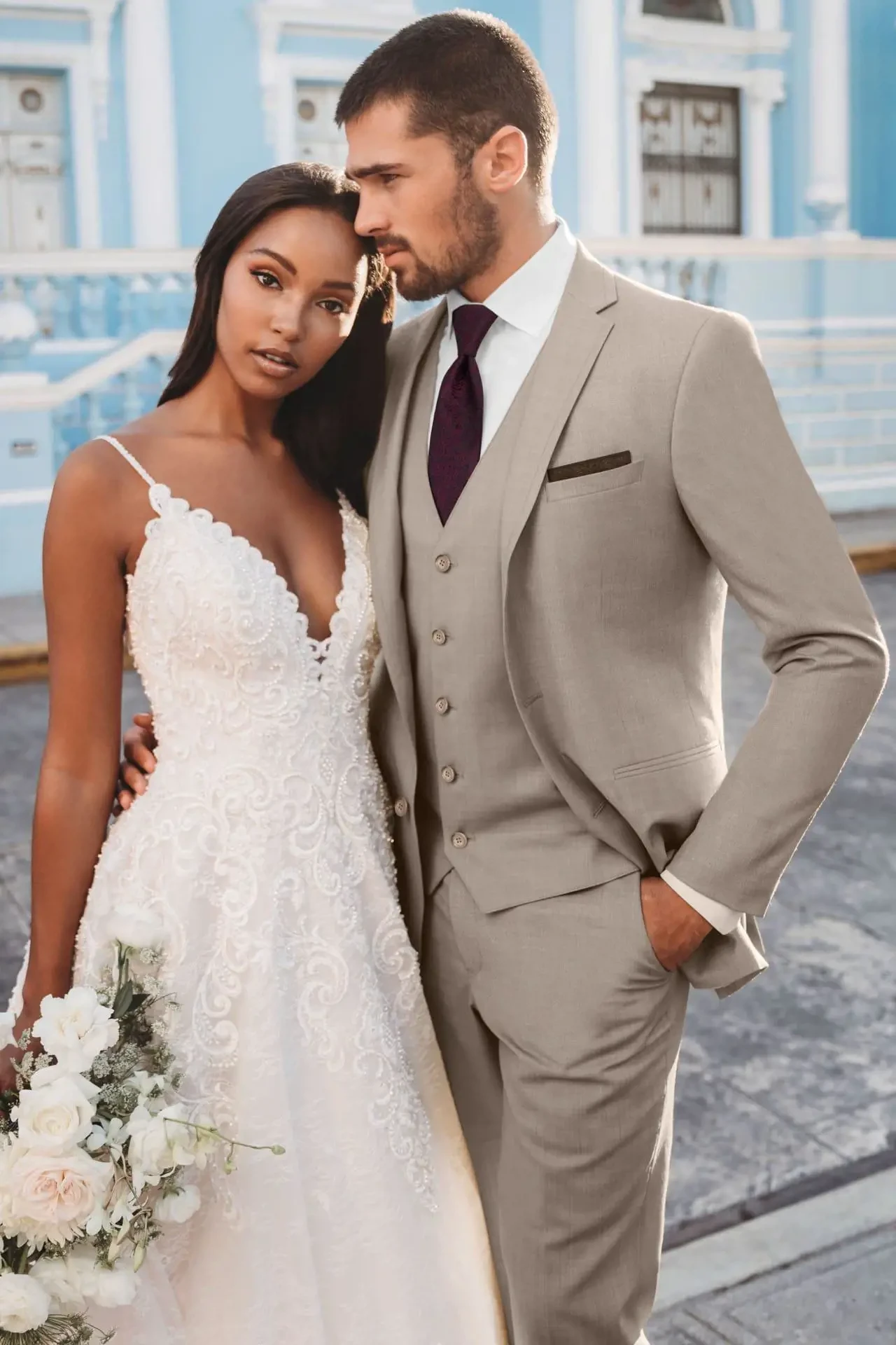 Сouple wearing a white gown and a gray suit