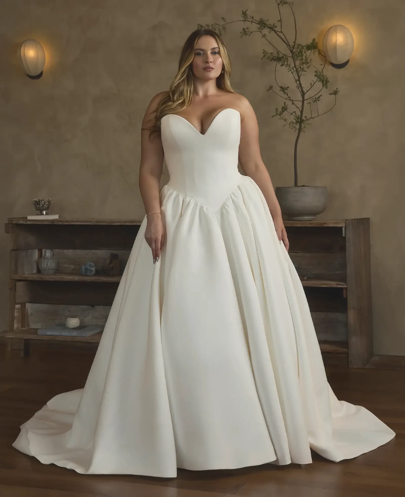 Model wearing a plus size gown by Casablanca Bridal